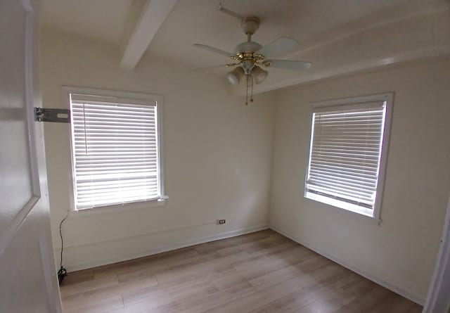 254 E 92nd St, Chicago, IL 60619 - spare room featuring light wood-type flooring, beamed ceiling, a ceiling fan, and baseboards