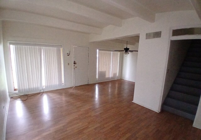 254 E 92nd St, Chicago, IL 60619 - unfurnished living room featuring wood finished floors, beamed ceiling, ceiling fan, and stairs