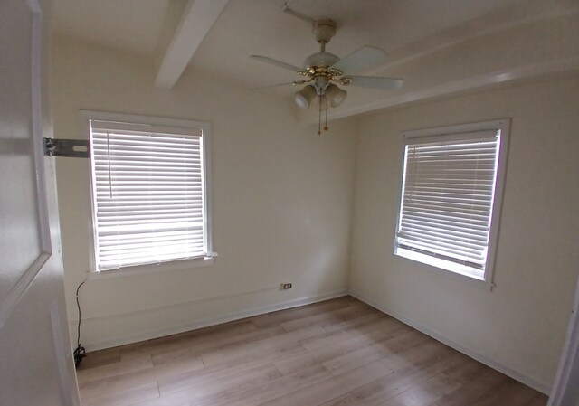 254 E 92nd St, Chicago, IL 60619 - spare room with beamed ceiling, light wood-style flooring, a ceiling fan, and baseboards