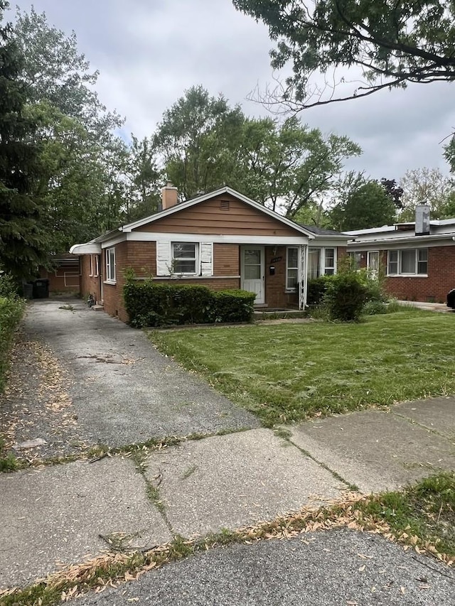 14630 Wabash Ave, Dolton, IL 60419 - ranch-style house with a chimney, brick siding, driveway, and a front yard