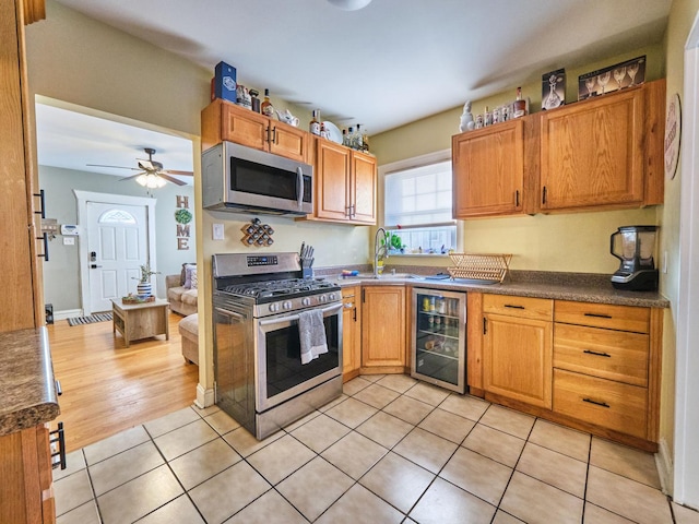 7314 W 58th St, Summit, IL 60501 - kitchen with stainless steel appliances, wine cooler, a sink, light tile patterned floors, and dark countertops