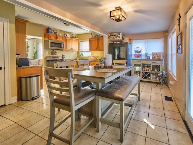 7314 W 58th St, Summit, IL 60501 - dining space featuring light tile patterned floors and baseboards
