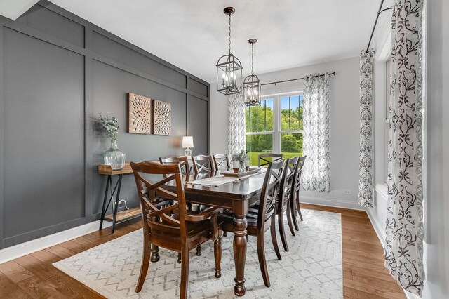 7166 Clubhouse Dr, Yorkville, IL 60560 - dining space featuring a chandelier, light wood-style floors, and baseboards