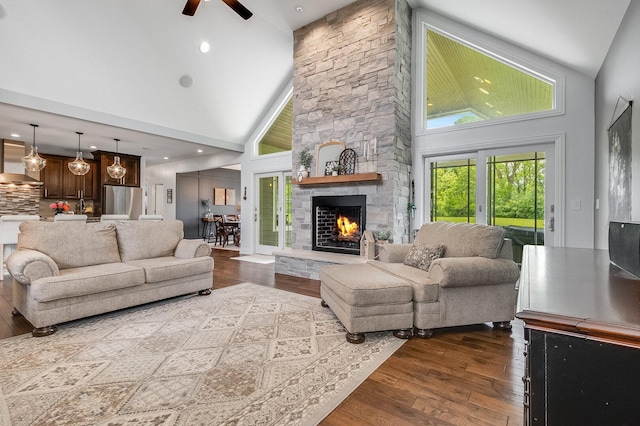 7166 Clubhouse Dr, Yorkville, IL 60560 - living room featuring high vaulted ceiling, dark wood-style floors, a stone fireplace, and ceiling fan