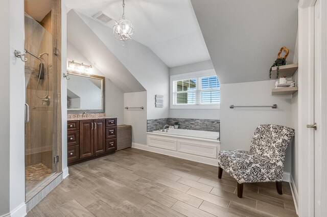 7166 Clubhouse Dr, Yorkville, IL 60560 - bathroom with vaulted ceiling, vanity, a shower stall, a garden tub, and wood finished floors