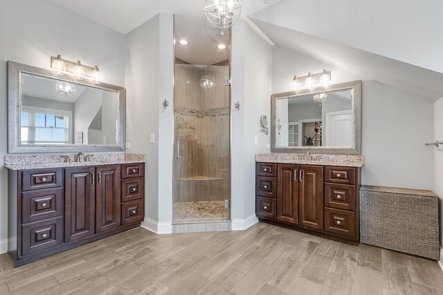 7166 Clubhouse Dr, Yorkville, IL 60560 - bathroom with a chandelier, a shower stall, wood finished floors, and vaulted ceiling