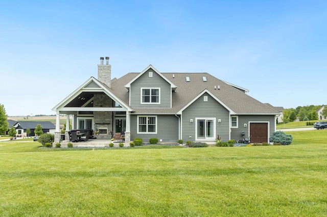 7166 Clubhouse Dr, Yorkville, IL 60560 - back of property with a chimney, a yard, a shingled roof, a patio, and stone siding
