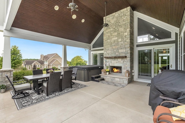 7166 Clubhouse Dr, Yorkville, IL 60560 - view of patio / terrace with a hot tub, outdoor dining area, and an outdoor stone fireplace