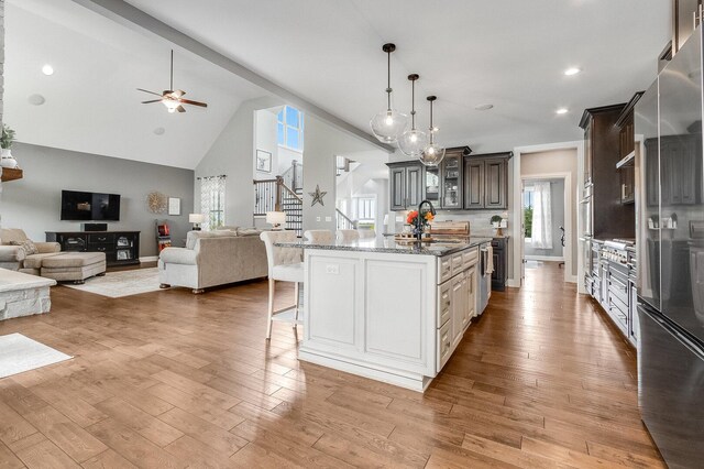 7166 Clubhouse Dr, Yorkville, IL 60560 - kitchen featuring freestanding refrigerator, a kitchen bar, open floor plan, high vaulted ceiling, and a ceiling fan