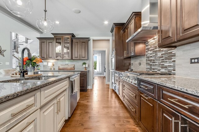 7166 Clubhouse Dr, Yorkville, IL 60560 - kitchen with wall chimney exhaust hood, a sink, a fireplace, dark brown cabinetry, and ceiling fan