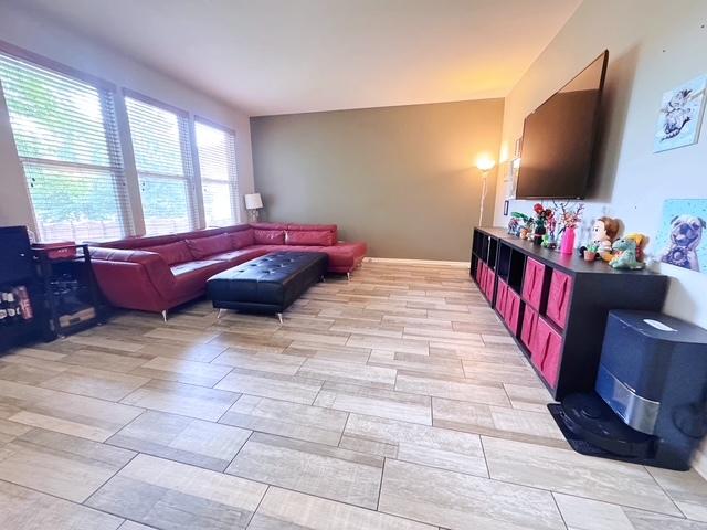 11319 Maplewood Dr, Plainfield, IL 60585 - living area with wood tiled floors