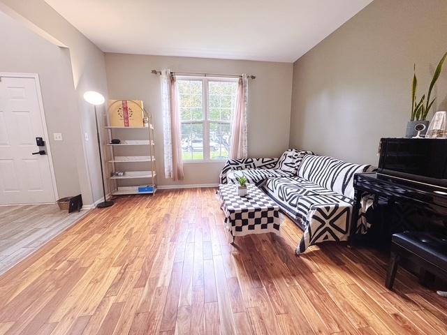 11319 Maplewood Dr, Plainfield, IL 60585 - living area featuring light wood finished floors and baseboards