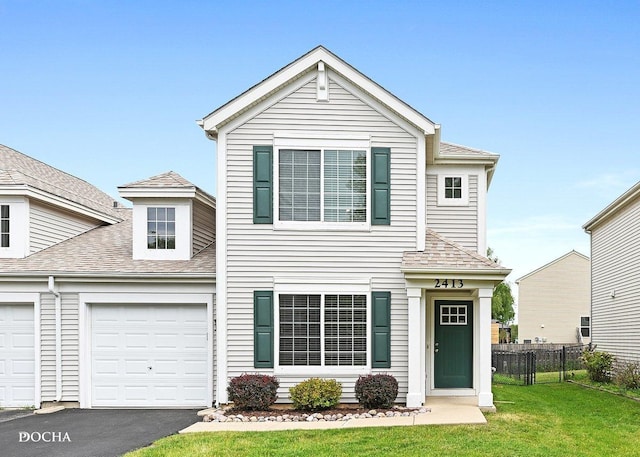 2413 Roxbury Ln, Montgomery, IL 60538 - traditional-style house with driveway, a shingled roof, and a garage