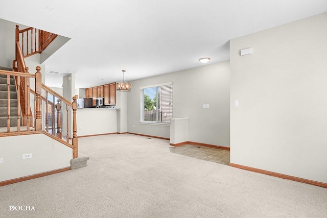 2413 Roxbury Ln, Montgomery, IL 60538 - unfurnished living room with light colored carpet, stairs, baseboards, and a chandelier
