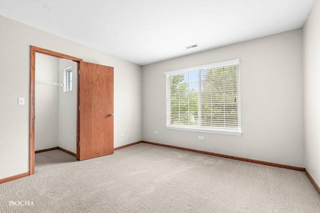 2413 Roxbury Ln, Montgomery, IL 60538 - unfurnished bedroom with baseboards, carpet, a closet, and a spacious closet