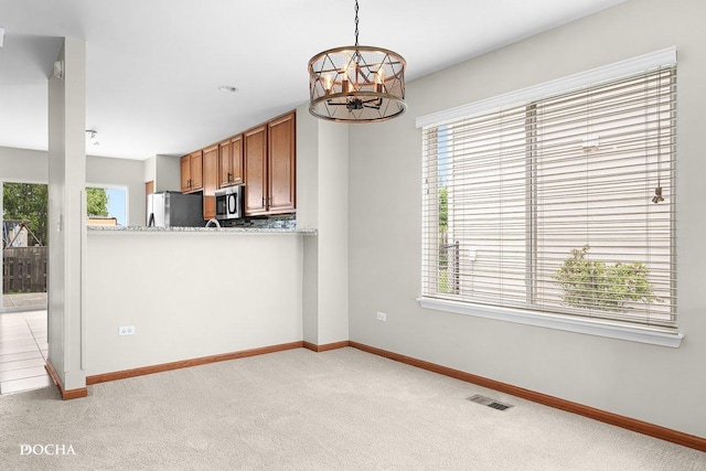 2413 Roxbury Ln, Montgomery, IL 60538 - kitchen with stainless steel appliances, light colored carpet, baseboards, and brown cabinets