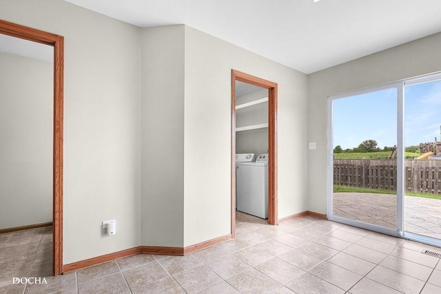 2413 Roxbury Ln, Montgomery, IL 60538 - unfurnished room featuring washing machine and clothes dryer, baseboards, and light tile patterned flooring