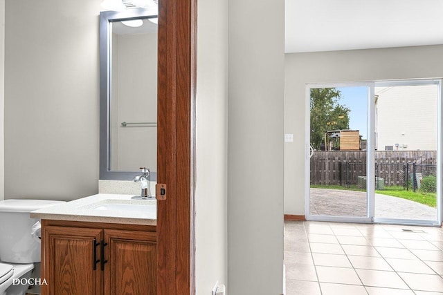 2413 Roxbury Ln, Montgomery, IL 60538 - bathroom with toilet, vanity, tile patterned floors, and baseboards