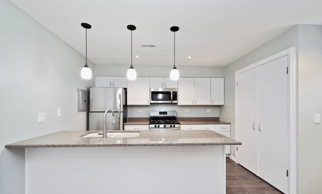 1547 Quaker Ln Unit 1547, Prospect Heights, IL 60070 - kitchen featuring stainless steel appliances, a sink, white cabinets, dark wood finished floors, and pendant lighting