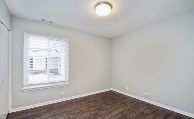 1547 Quaker Ln Unit 1547, Prospect Heights, IL 60070 - spare room with dark wood-type flooring and baseboards