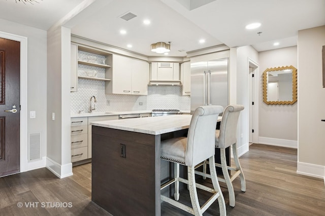 25 E Superior St Unit 2403, Chicago, IL 60611 - kitchen with a sink, baseboards, open shelves, light countertops, and dark wood-style flooring