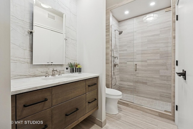 25 E Superior St Unit 2403, Chicago, IL 60611 - full bathroom with vanity, a stall shower, toilet, recessed lighting, and tasteful backsplash