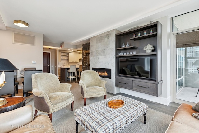 25 E Superior St Unit 2403, Chicago, IL 60611 - living room featuring a fireplace, baseboards, and dark wood finished floors