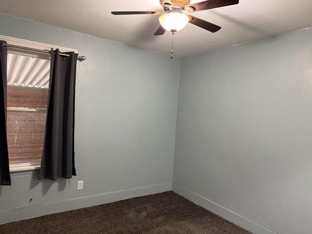 119 S Washington St, Wilmington, IL 60481 - empty room with dark colored carpet, ceiling fan, and baseboards