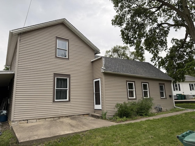 119 S Washington St, Wilmington, IL 60481 - back of house featuring a lawn, cooling unit, entry steps, a patio, and a shingled roof