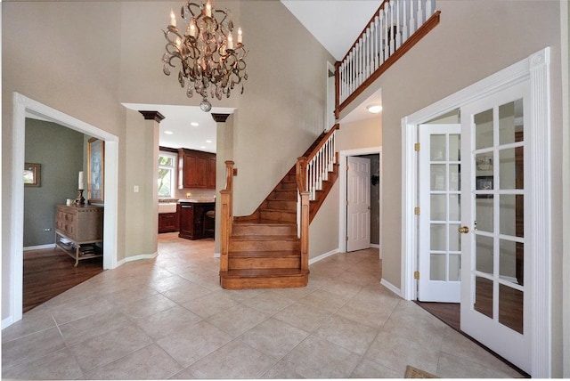 1537 Monarch Cir, Naperville, IL 60564 - entrance foyer featuring french doors, stairs, a high ceiling, baseboards, and a chandelier