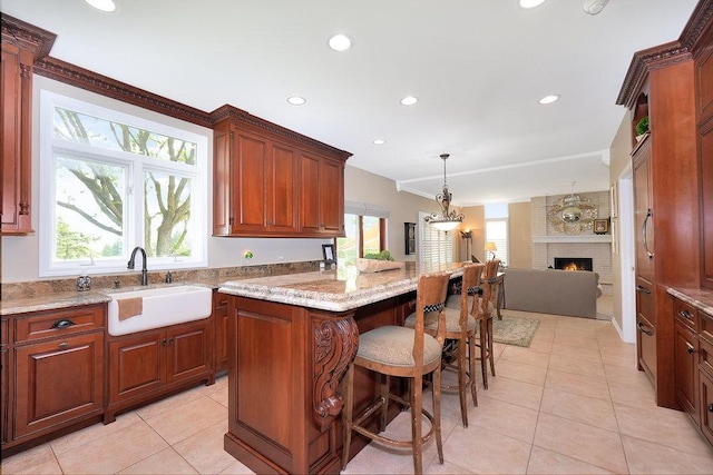 1537 Monarch Cir, Naperville, IL 60564 - kitchen featuring a sink, a kitchen island, open floor plan, light tile patterned flooring, and a kitchen breakfast bar