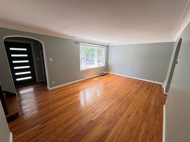 6649 S Karlov Ave, Chicago, IL 60629 - unfurnished room featuring arched walkways, wood finished floors, baseboards, and ornamental molding