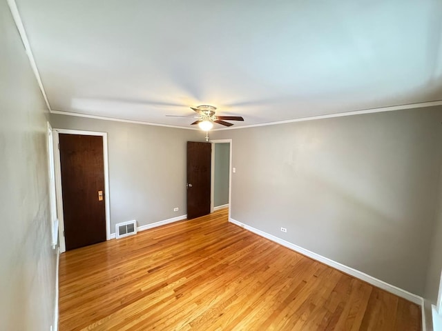 6649 S Karlov Ave, Chicago, IL 60629 - empty room with a ceiling fan, light wood-style flooring, ornamental molding, and baseboards
