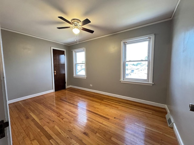 6649 S Karlov Ave, Chicago, IL 60629 - spare room featuring ornamental molding, light wood-style floors, baseboards, and ceiling fan