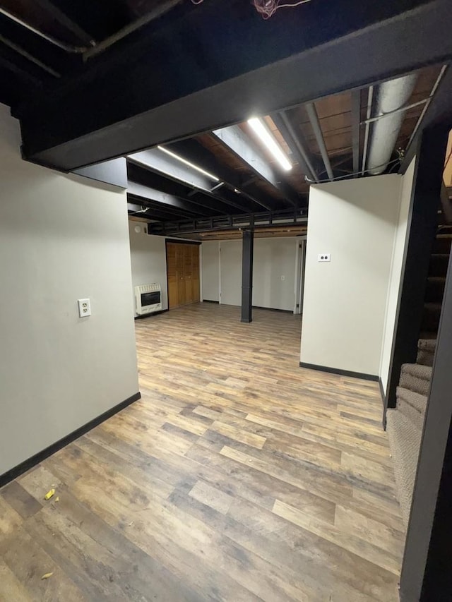 6649 S Karlov Ave, Chicago, IL 60629 - finished below grade area with stairway, baseboards, light wood-type flooring, and heating unit