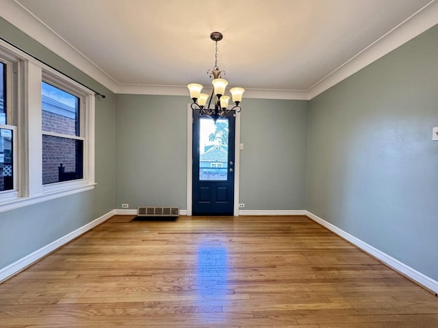 6649 S Karlov Ave, Chicago, IL 60629 - unfurnished room with healthy amount of natural light, a chandelier, baseboards, and crown molding