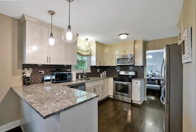 562 Revere Ave, Westmont, IL 60559 - kitchen featuring stainless steel appliances, a peninsula, decorative backsplash, dark wood-style flooring, and light stone countertops