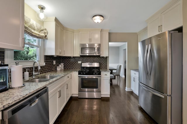 562 Revere Ave, Westmont, IL 60559 - kitchen with appliances with stainless steel finishes, dark wood-style flooring, decorative backsplash, and light stone counters