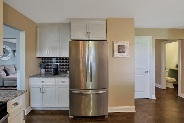 562 Revere Ave, Westmont, IL 60559 - kitchen featuring freestanding refrigerator, backsplash, light stone counters, dark wood-style flooring, and white cabinets
