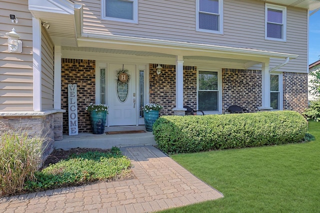 562 Revere Ave, Westmont, IL 60559 - entrance to property with brick siding, a lawn, and covered porch