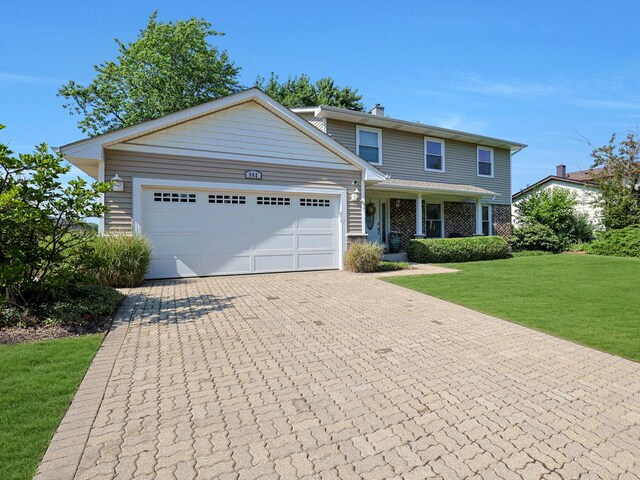 562 Revere Ave, Westmont, IL 60559 - view of front of property featuring a garage, a front lawn, decorative driveway, and a chimney