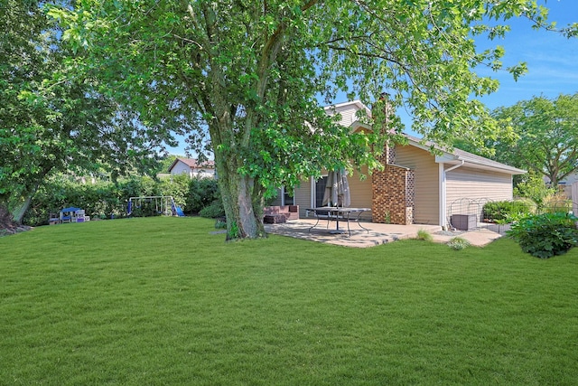 562 Revere Ave, Westmont, IL 60559 - view of grassy yard featuring a patio and a playground