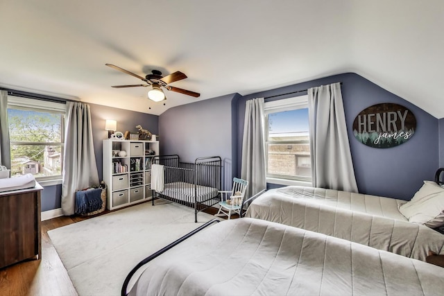 9906 S Saint Louis Ave, Evergreen Park, IL 60805 - bedroom with vaulted ceiling, wood finished floors, multiple windows, a ceiling fan, and baseboards