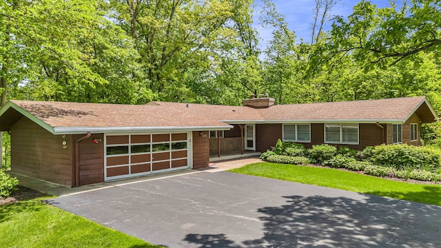 24721 S Walnut St, Crete, IL 60417 - single story home featuring driveway, a garage, a chimney, and a shingled roof
