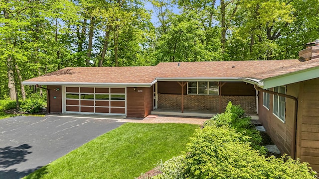 24721 S Walnut St, Crete, IL 60417 - view of front of house featuring an attached garage, driveway, a chimney, and a shingled roof