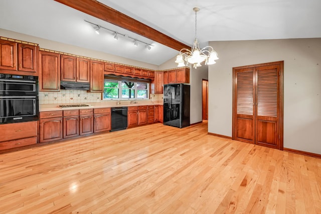 24721 S Walnut St, Crete, IL 60417 - kitchen featuring black appliances, a chandelier, brown cabinetry, and backsplash