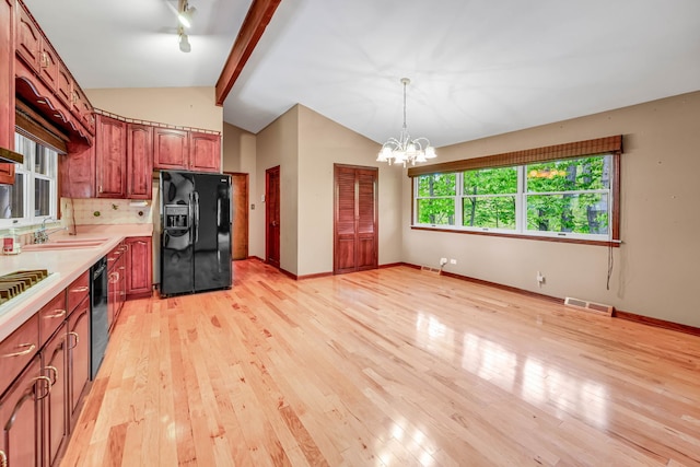 24721 S Walnut St, Crete, IL 60417 - kitchen featuring black appliances, a sink, light countertops, a chandelier, and light wood-style floors