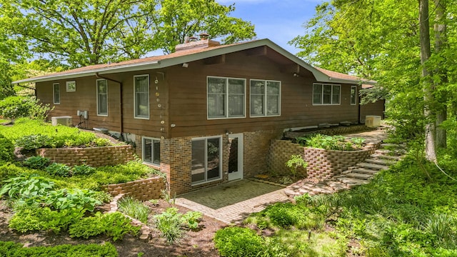 24721 S Walnut St, Crete, IL 60417 - rear view of house with a chimney, a patio area, and central AC unit