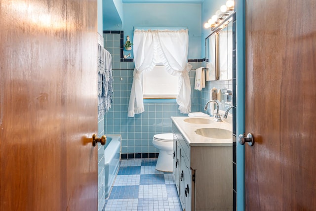 8952 S E End Ave, Chicago, IL 60617 - full bathroom with double vanity, tile patterned floors, toilet, and tile walls