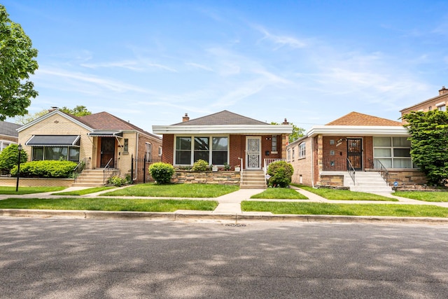 8952 S E End Ave, Chicago, IL 60617 - bungalow featuring brick siding, a front lawn, and entry steps